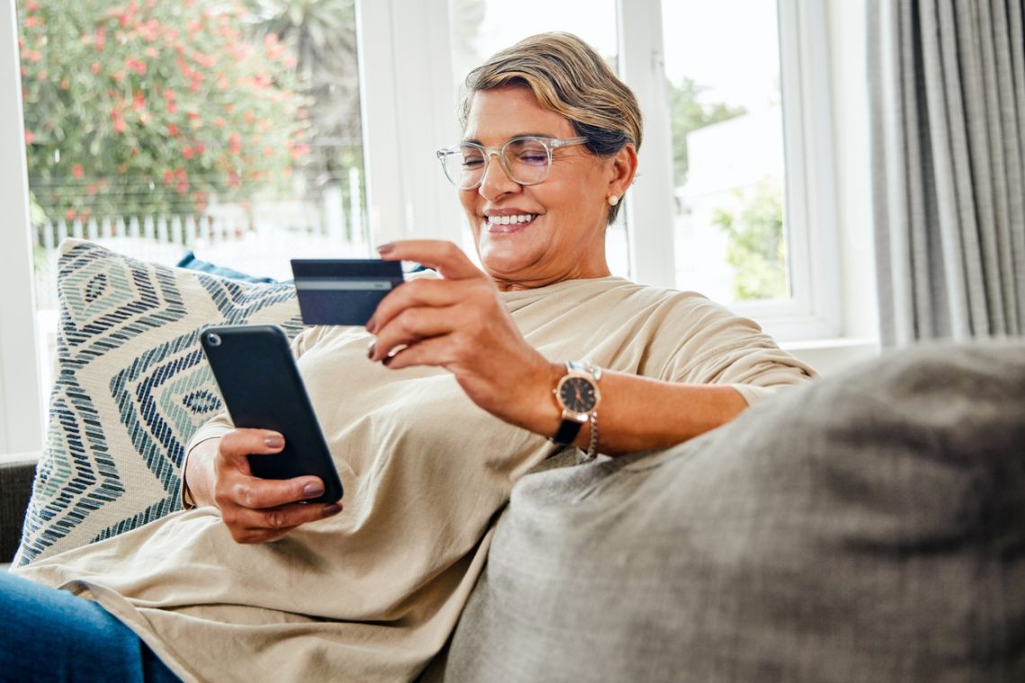 Older woman using prepaid card