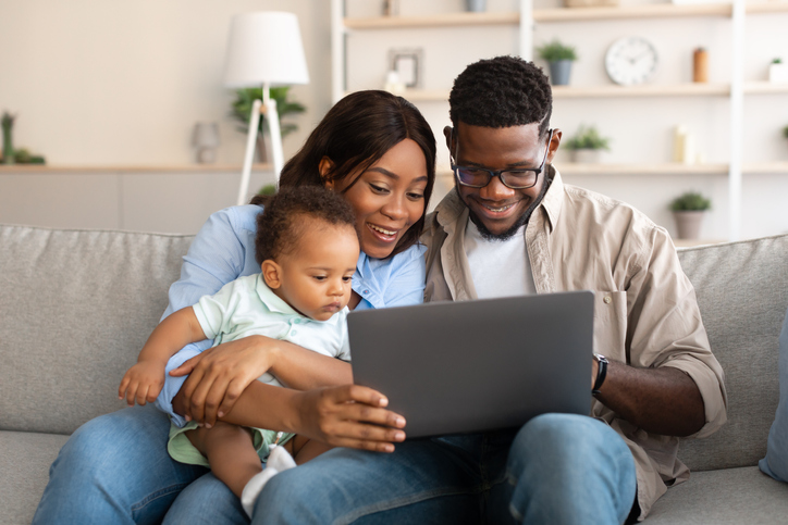 Young family looking at laptop for add-on products