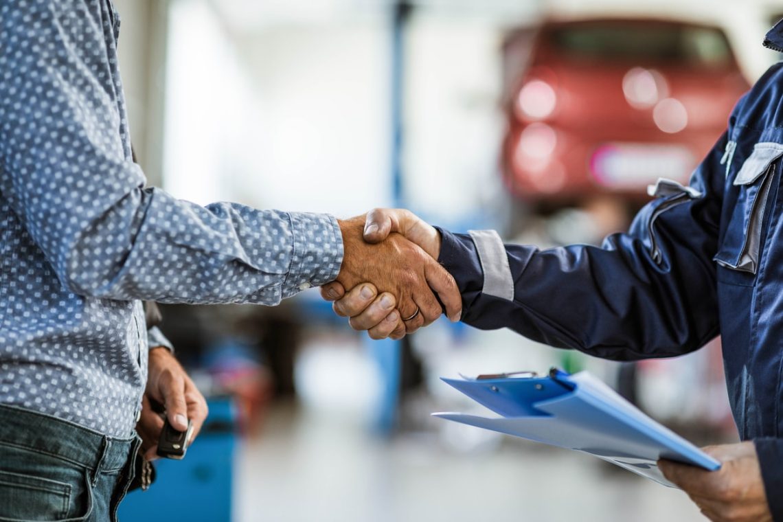 Shaking hands at an auto body shop