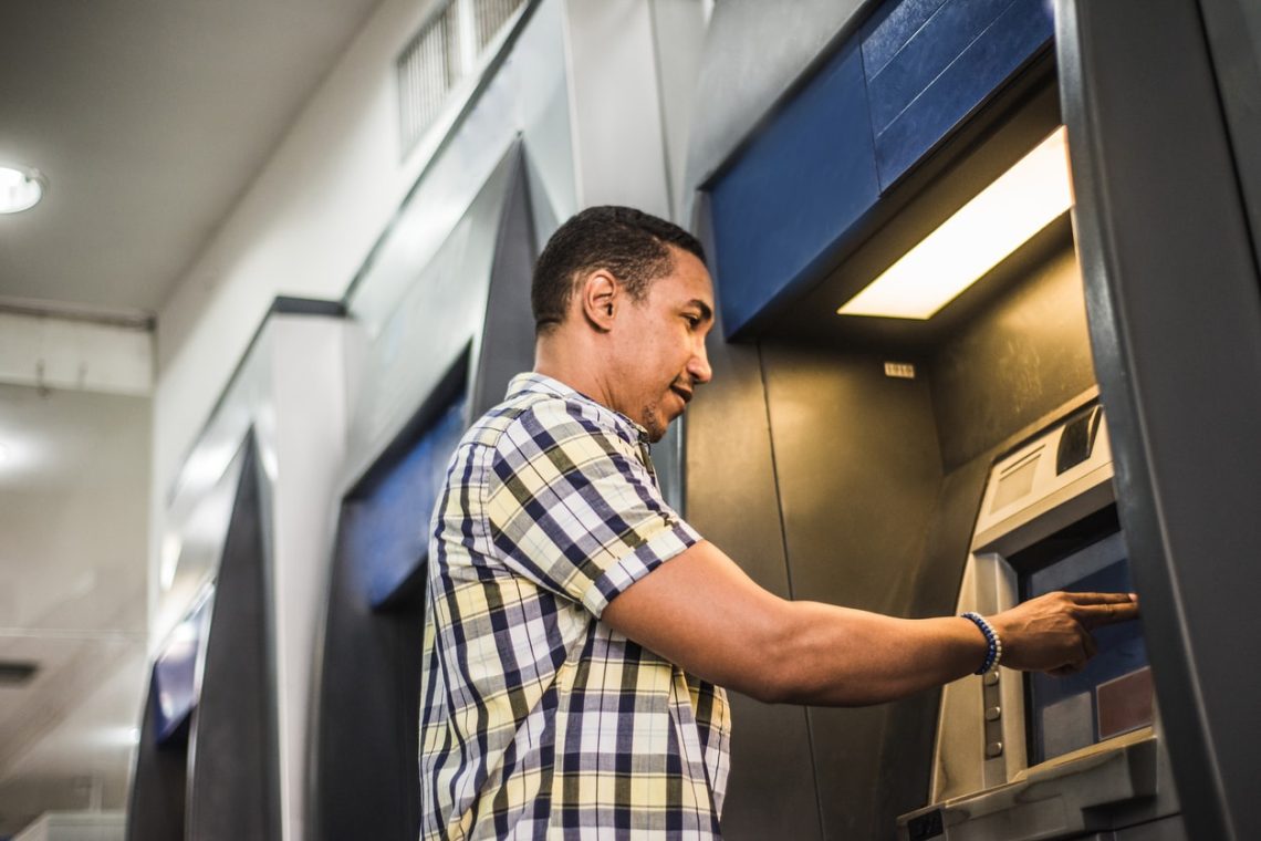 Hispanic man using an ATM