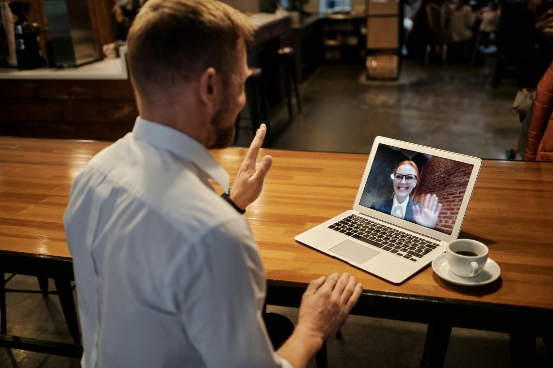 man videochatting with businesswoman