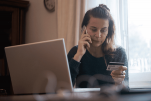 Customer reviewing account activity for banking scam warning signs and fraud prevention